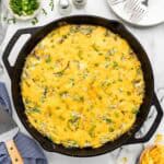 Baked breakfast recipe in a cast iron skillet.