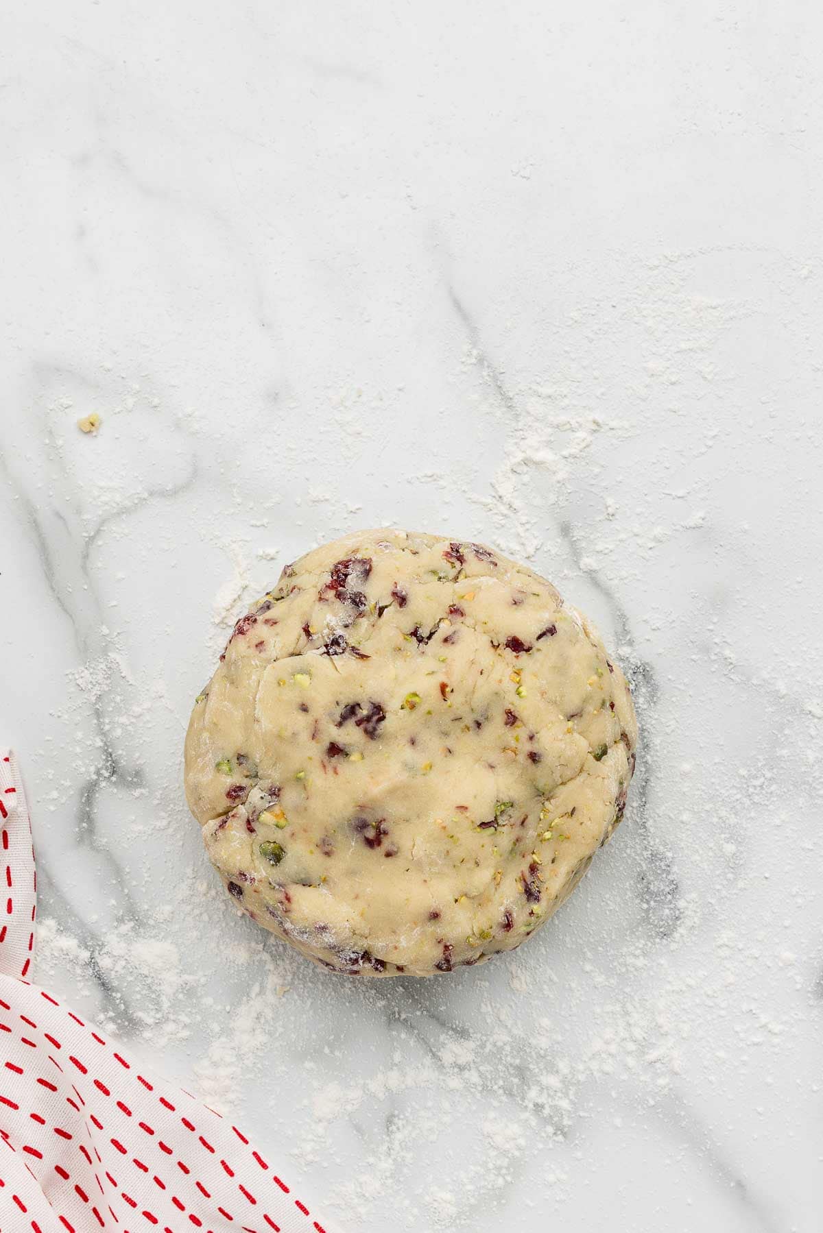 Cookie dough on a counter sprinkled with flour.