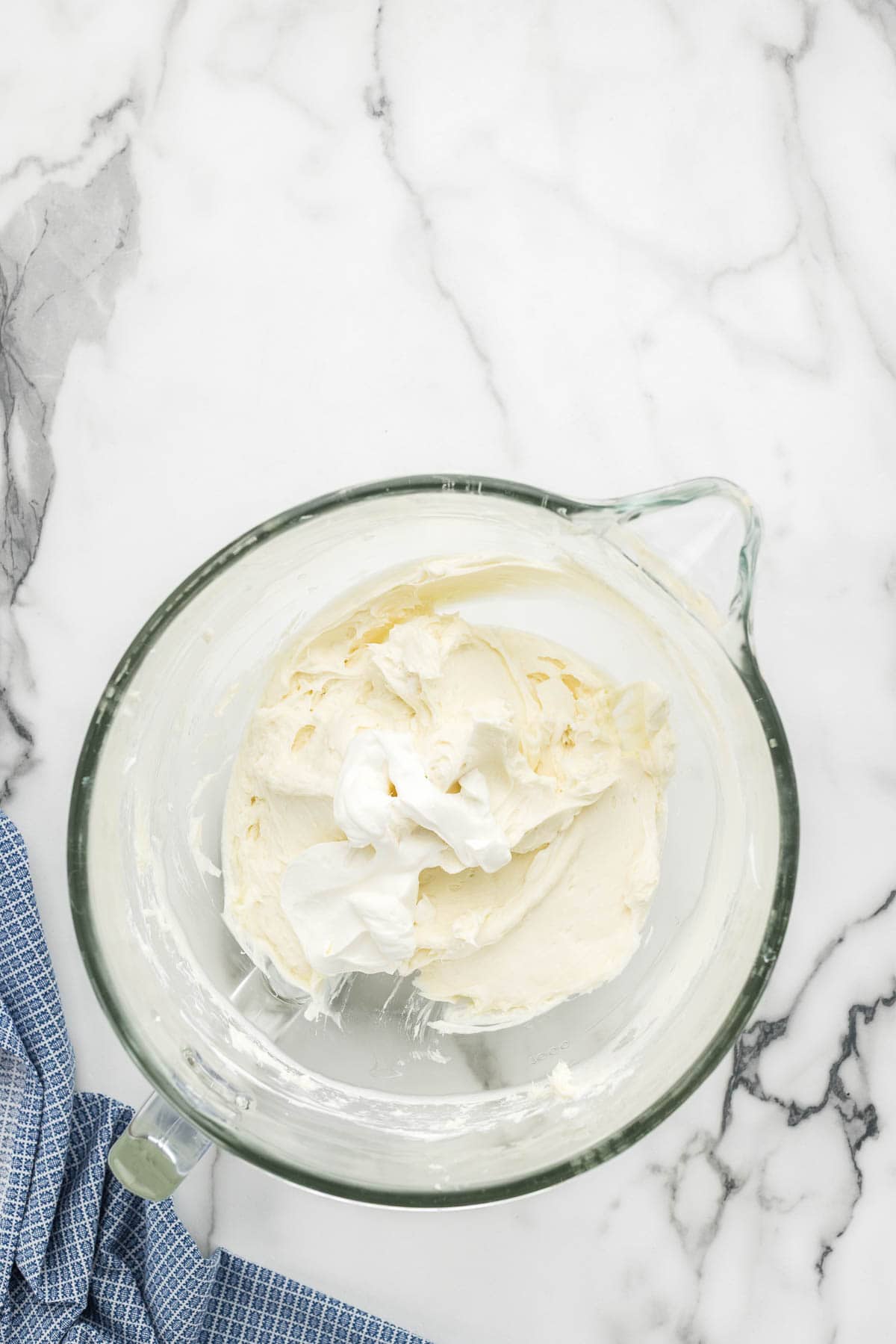 Cheesecake mixture in a glass mixing dish.