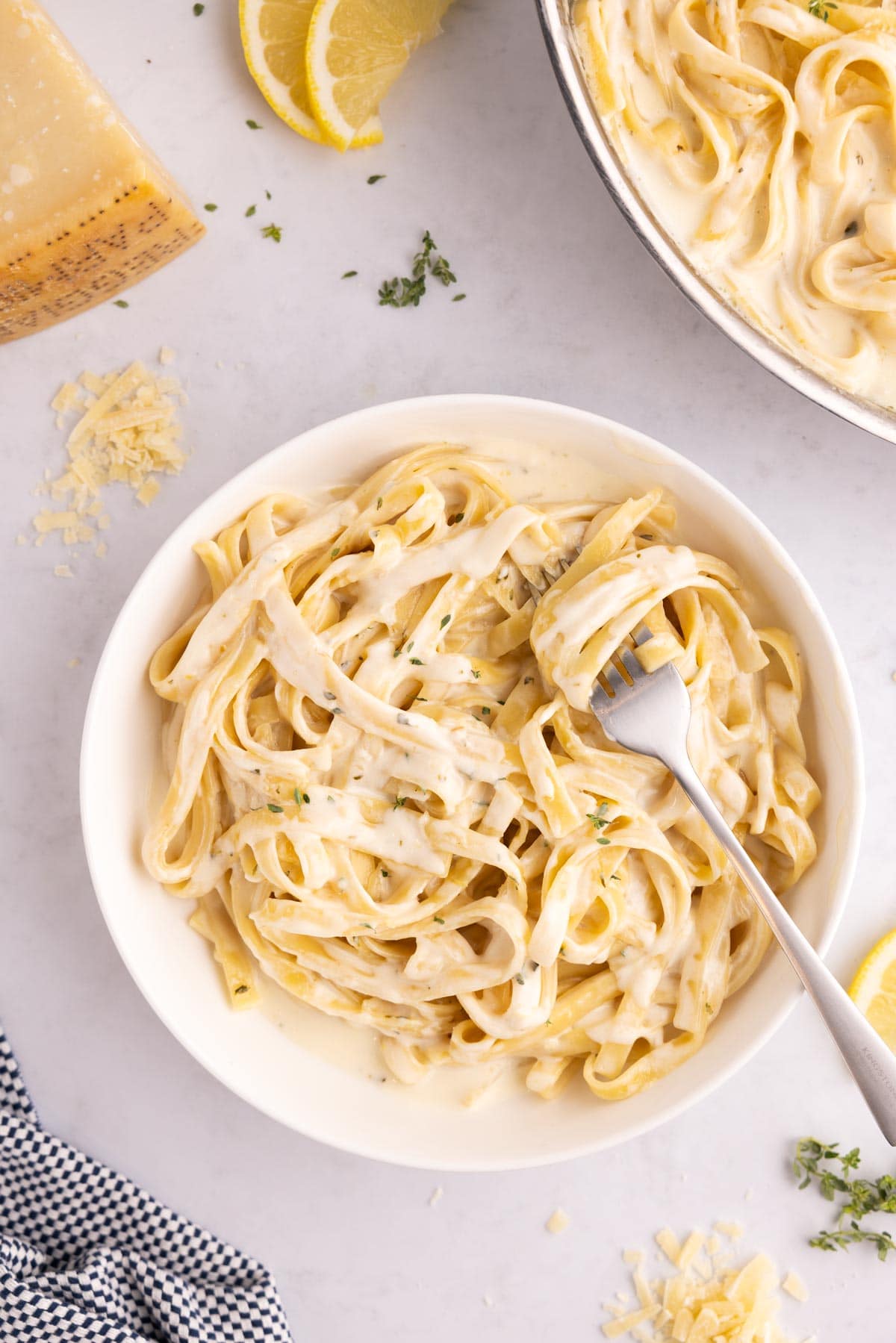 A serving of lemon alfredo in a bowl with a fork.