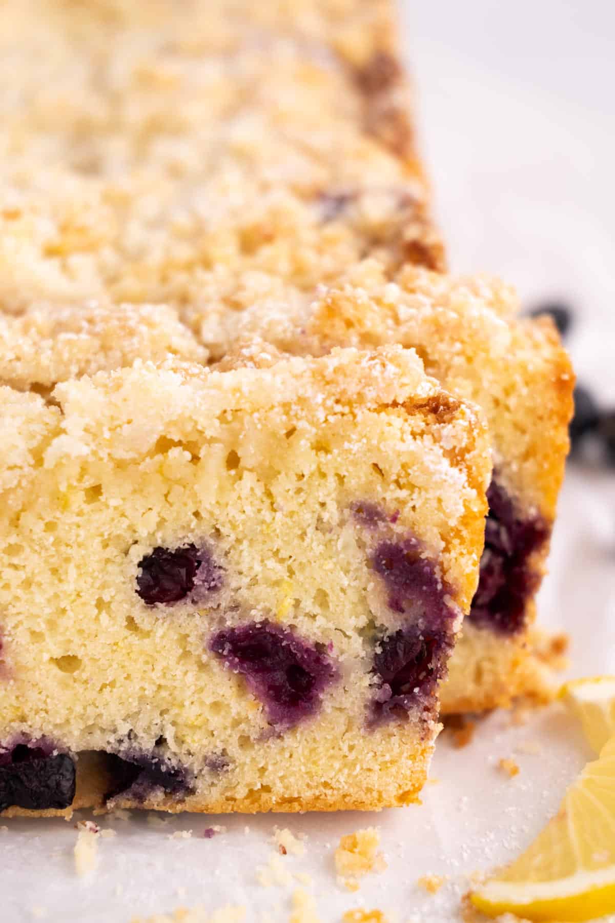 Closeup of a slice of lemon blueberry loaf.