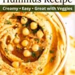 Creamy hummus in a glass white bowl with an overlay of text.