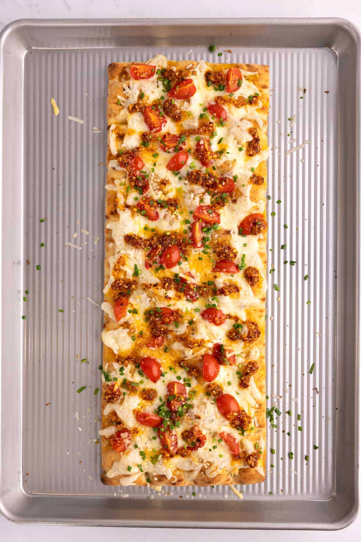 Baked pizza on a large sheet pan.