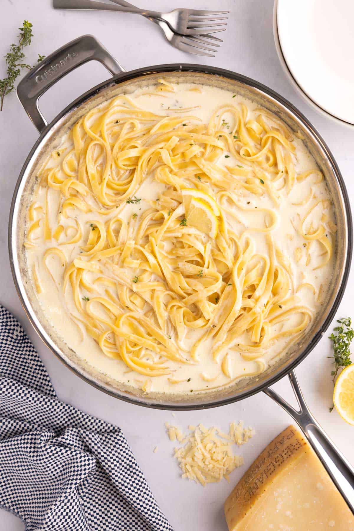 A large pot of lemon alfredo topped with lemon slices.