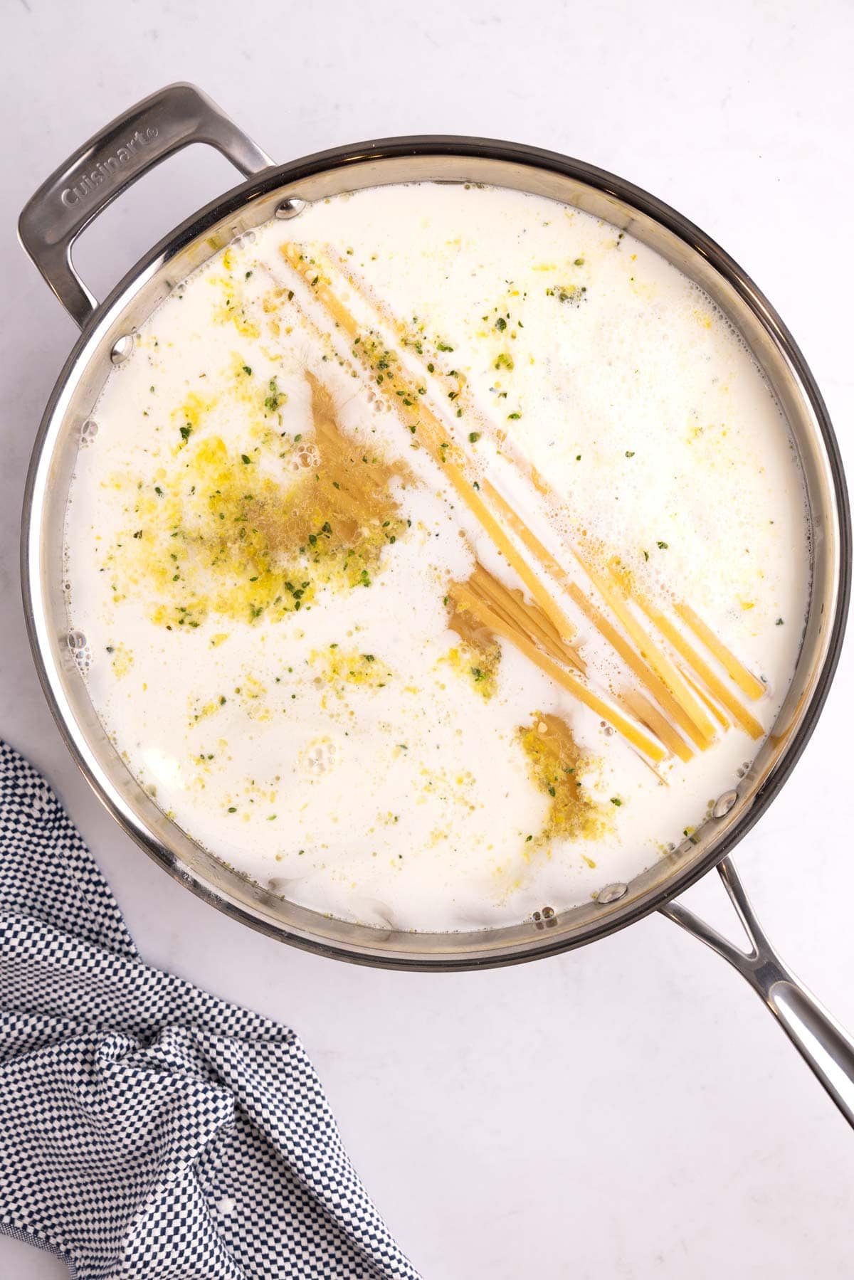 alfredo ingredients added to one large pot.