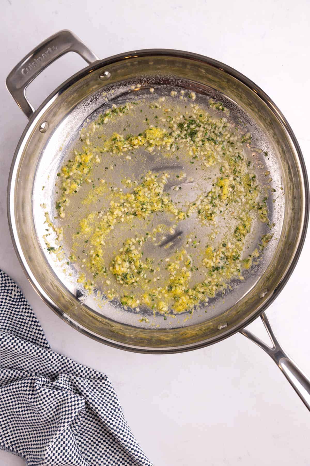 Lemon and garlic combined at the bottom of a cooking dish.