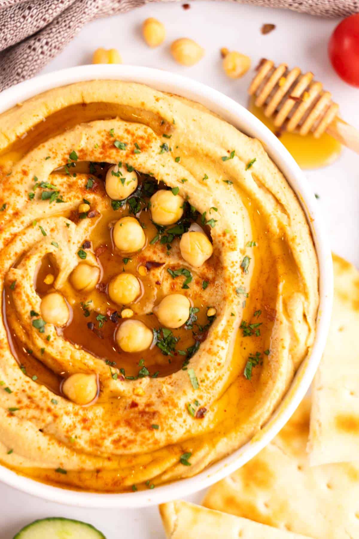 Hummus served in a white dish.