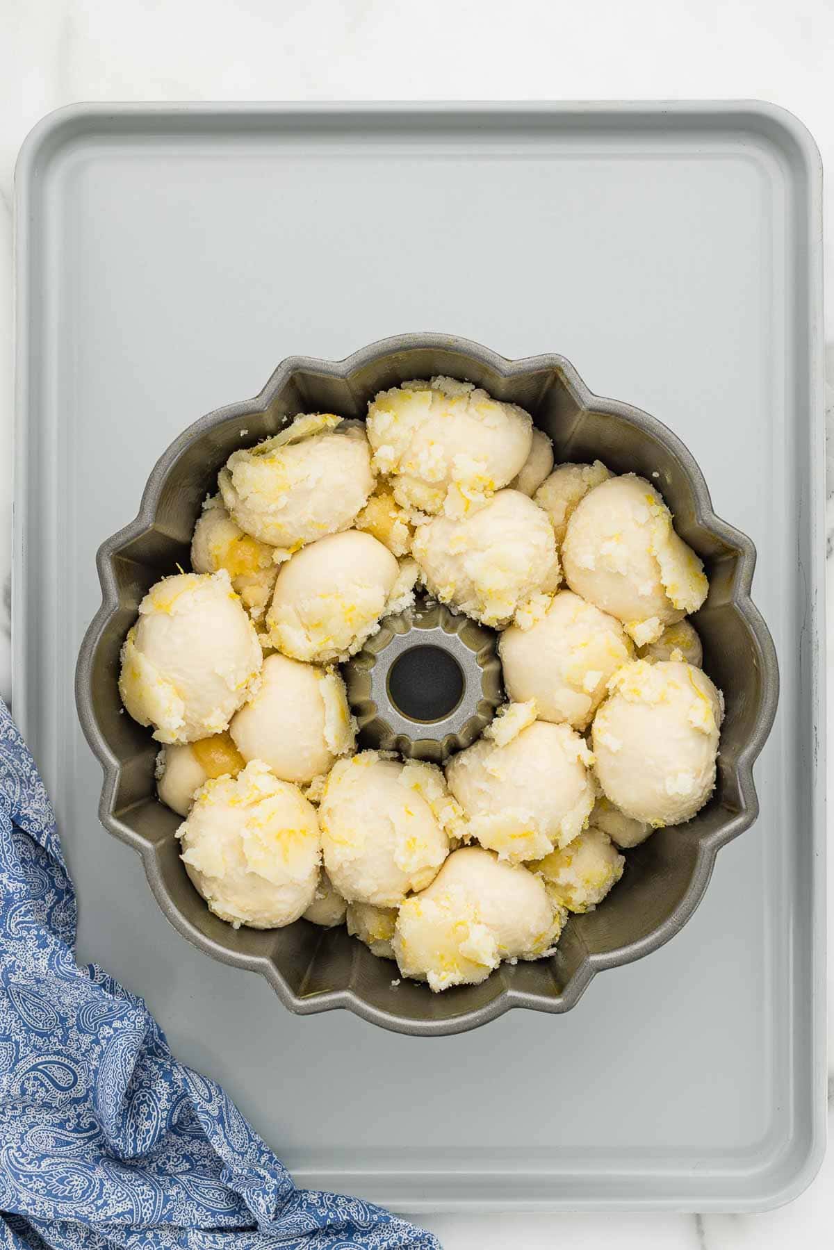 Dough balls stacked in a bundt cake pan.