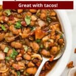 An overlay of text over an image of a bowl of borracho beans with a spoon.