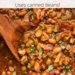 Closeup of a pot of beans with a wooden cooking spoon with a graphic overlay.
