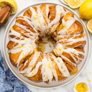 Overhead of lemon monkey bread topped with lemon zest on a glass white platter.