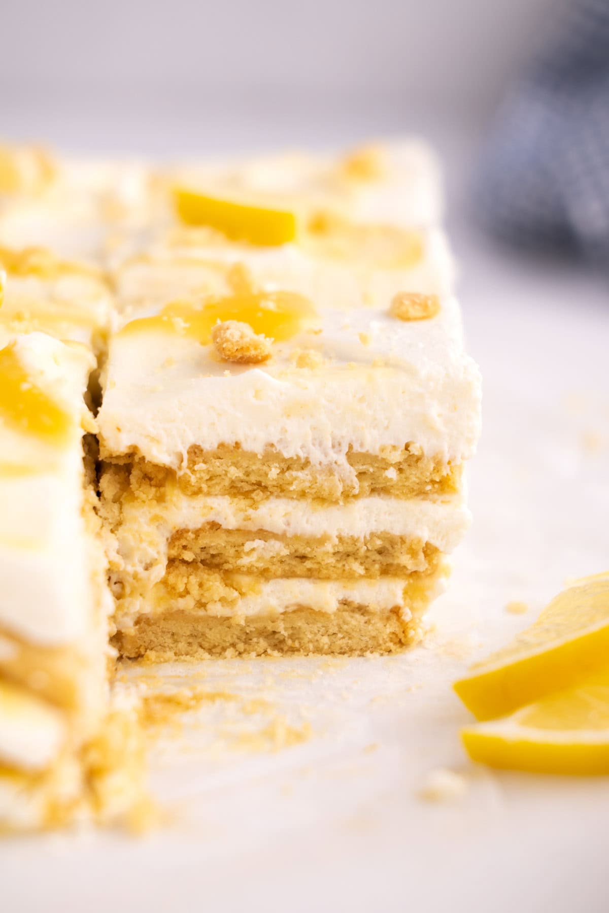 Closeup of the side of a lemon icebox cake square.