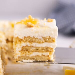 A lemon icebox slice sitting on a serving spatula.