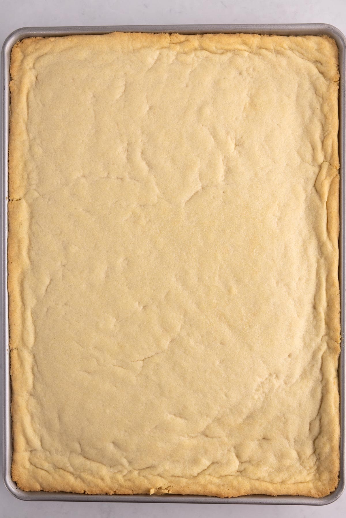 Baked cookie dough in a large pan.