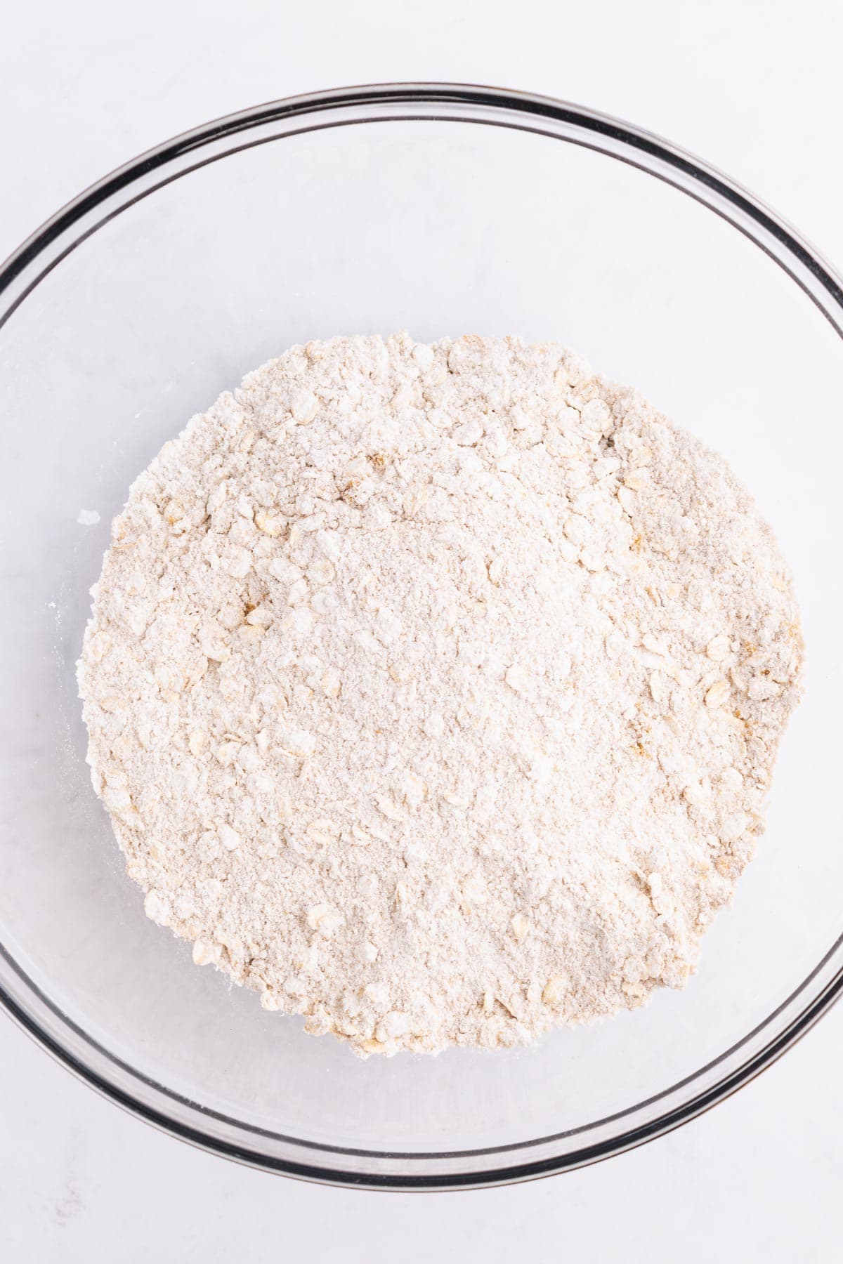 Dry ingredients in a large glass mixing bowl.