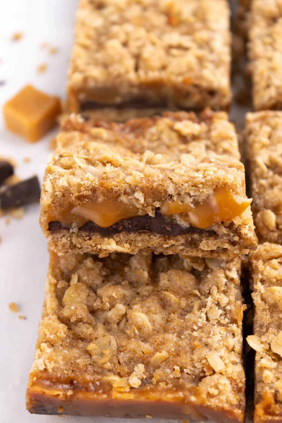 Caramelita bars in a pile on parchment.