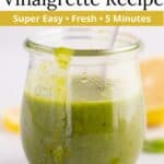 A jar of lemon basil dressing with a spoon dipped in it and a graphic overlay of text at the top of the image.