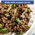 Text overlayed on an image of a ground beef bowl with green beans and a fork.