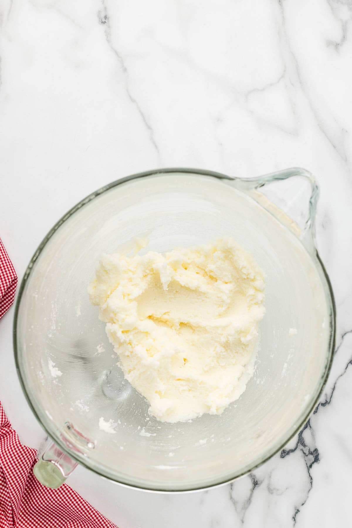 Butter mixed in a glass measuring cup.