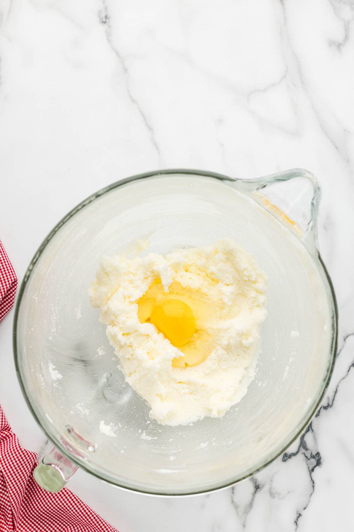 Eggs added to a measuring glass of batter.