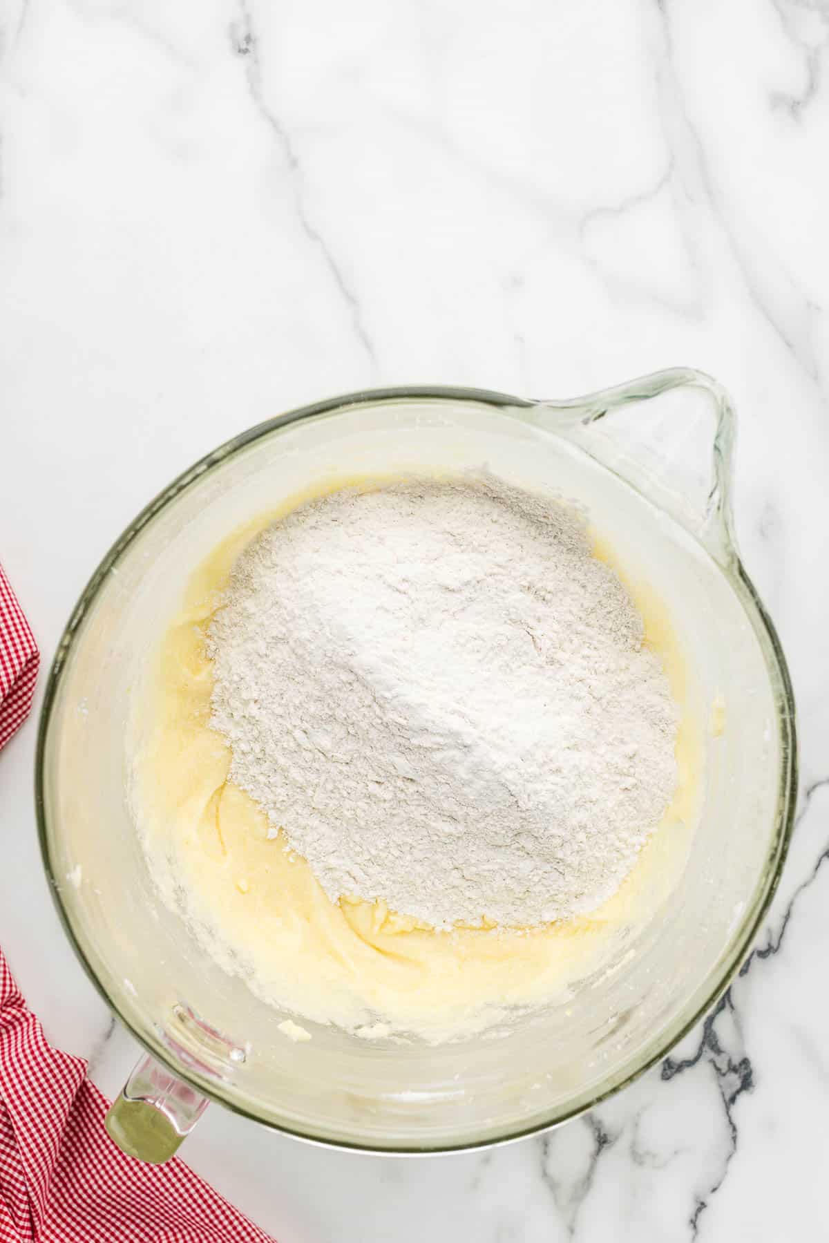 Wet and dry ingredients combined into a large mixing dish.