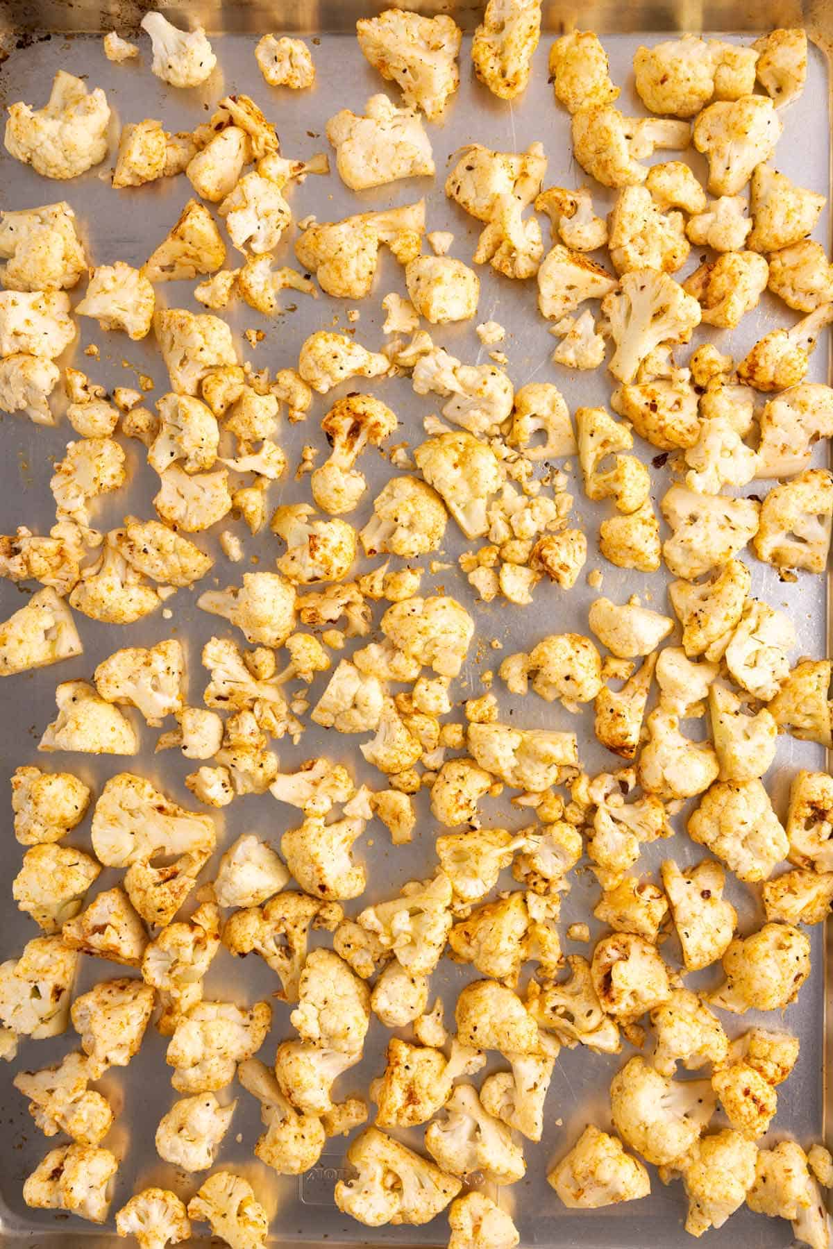 A sheet pan with cauliflower spread on it.