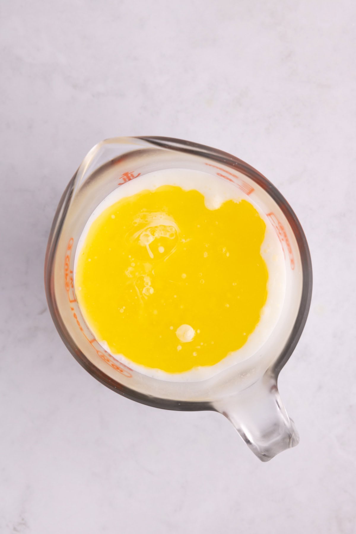 Wet ingredients in a glass mixing dish.