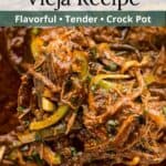 A bite of ropa vieja on a wooden spoon with an overlay of text.
