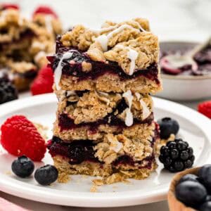 Berry bars stacked vertically on a white serving dish.