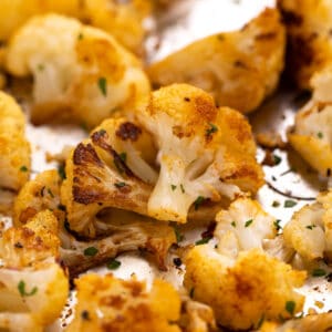 Cauliflower clustered together on a pan.