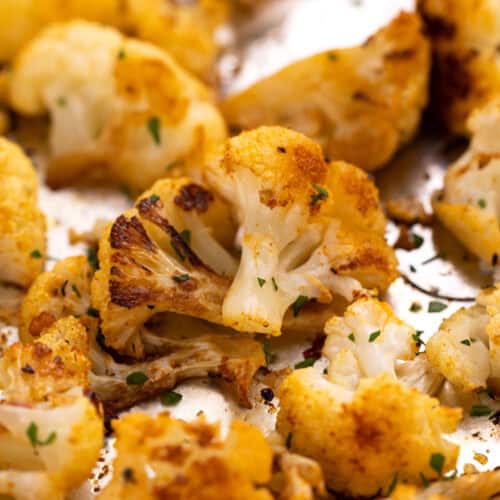 Cauliflower clustered together on a pan.