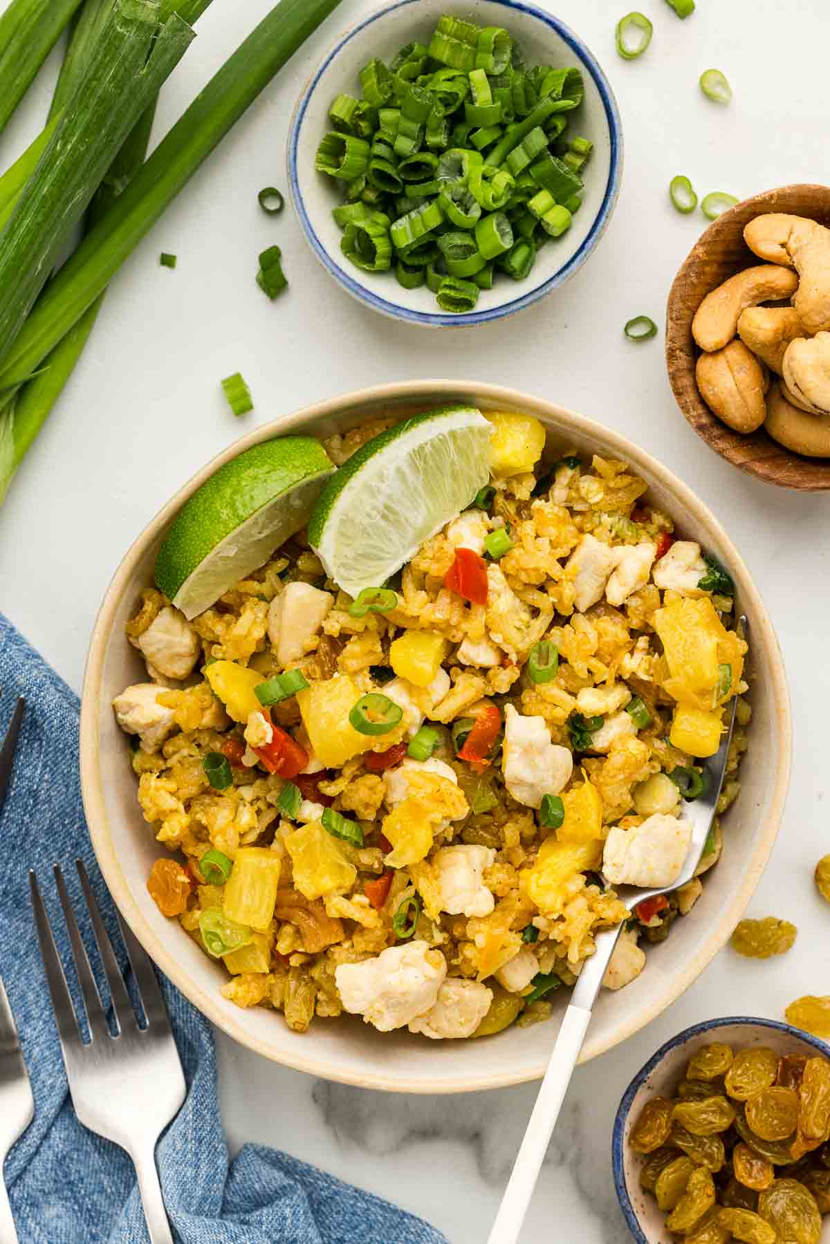 CLoseup of pineapple fried rice in a small bowl with a fork.