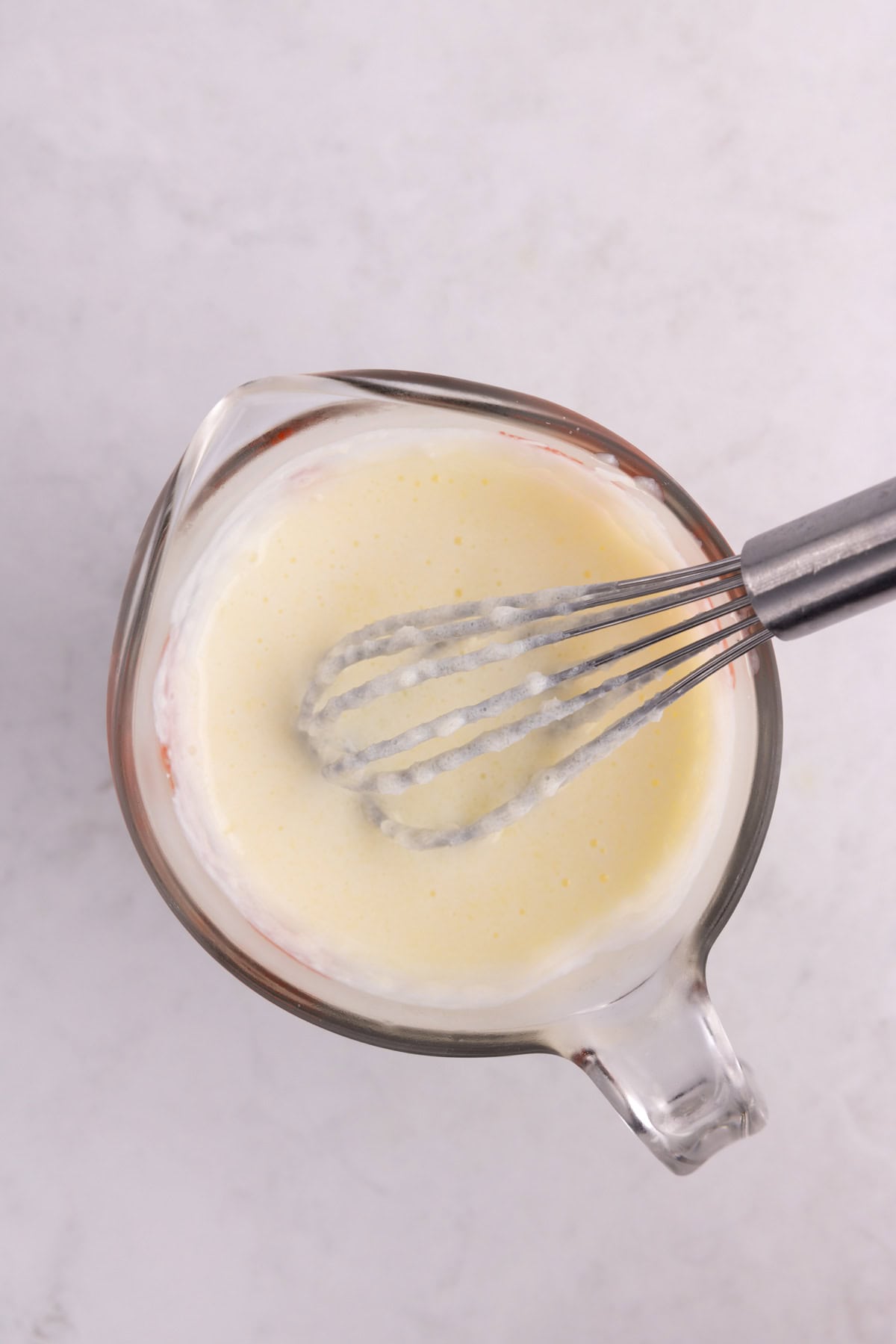 Wet ingredients combined with a whisk.