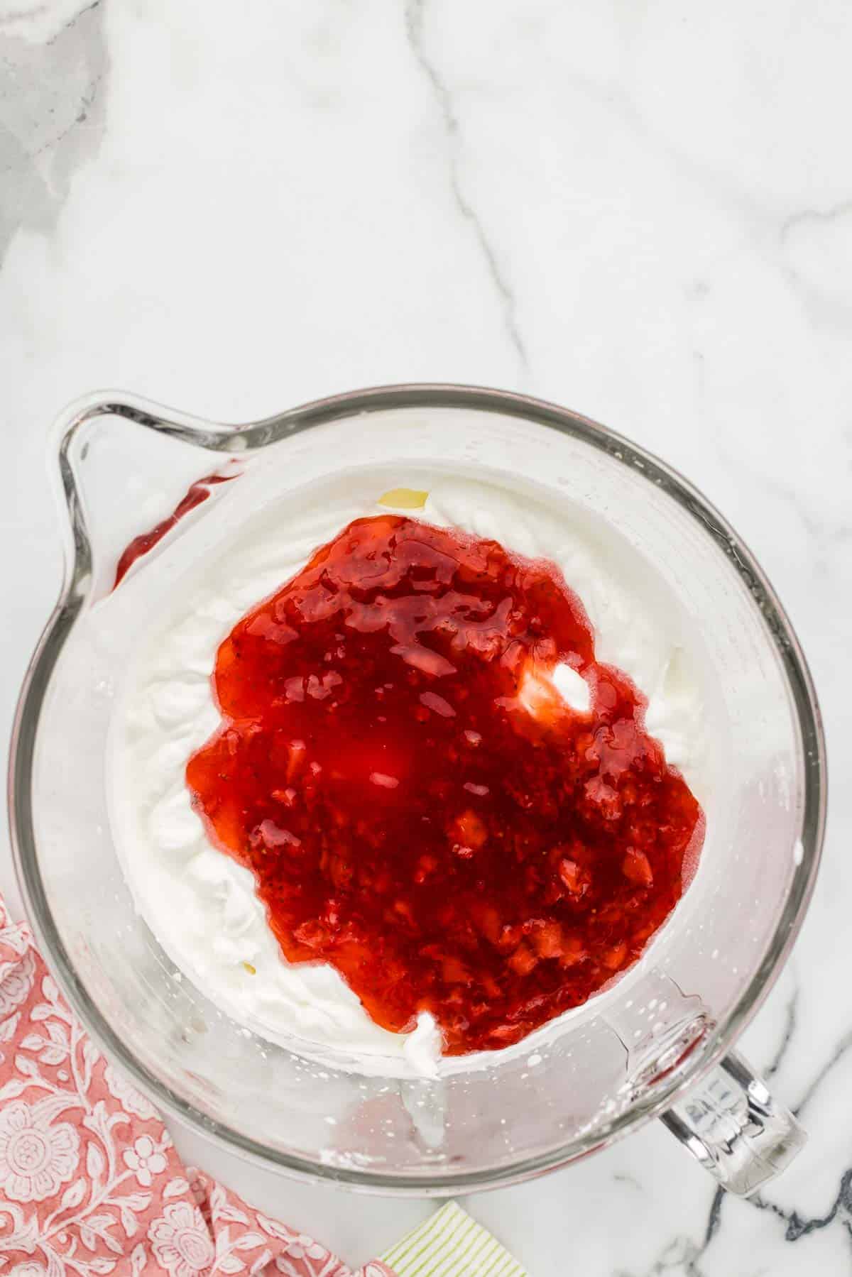 Strawberry sauce ingredients in a glass measuring cup.