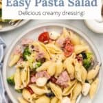 A small serving of pasta salad with a fork and an overlay of text.