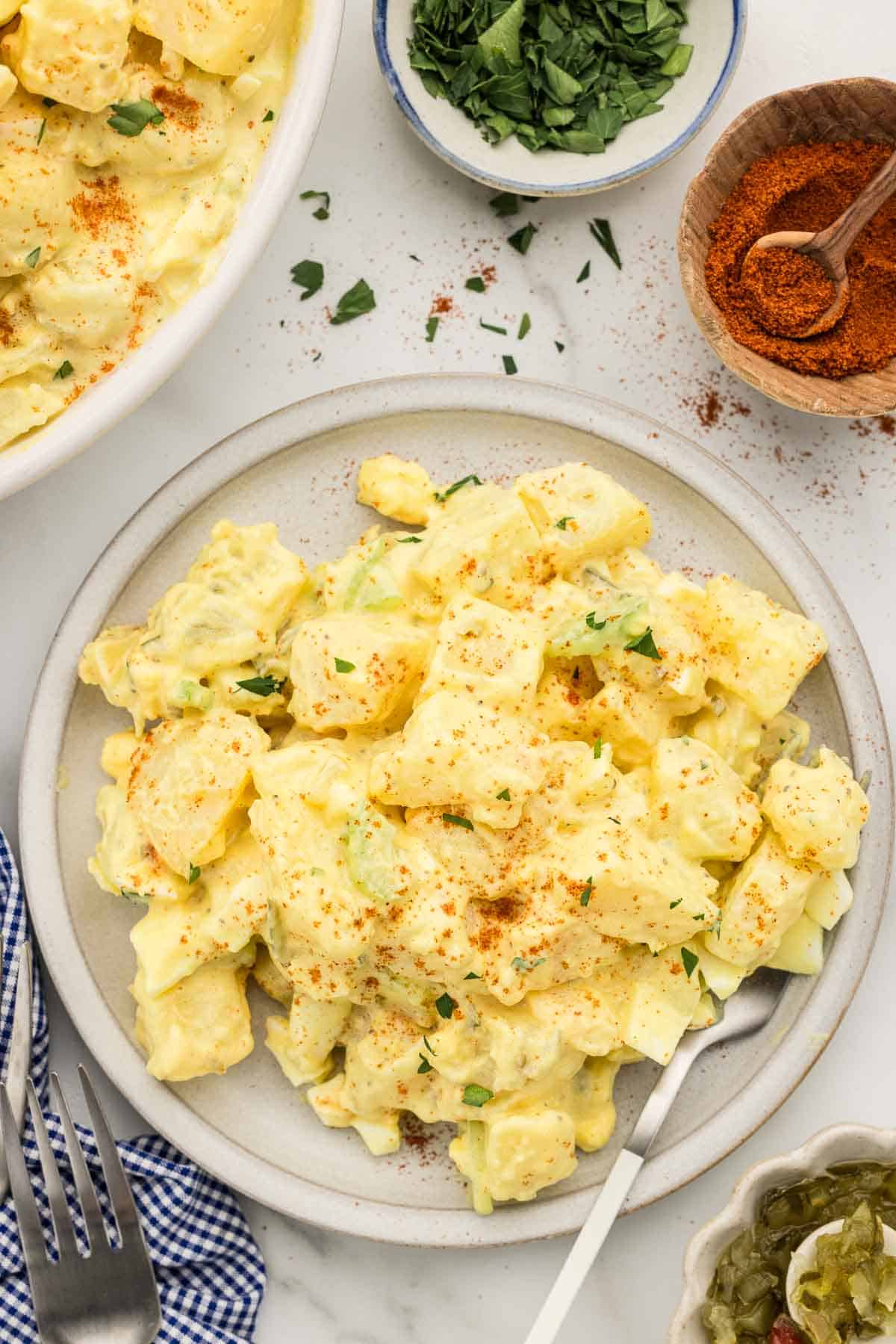 Potato salad on a small plate with a fork.