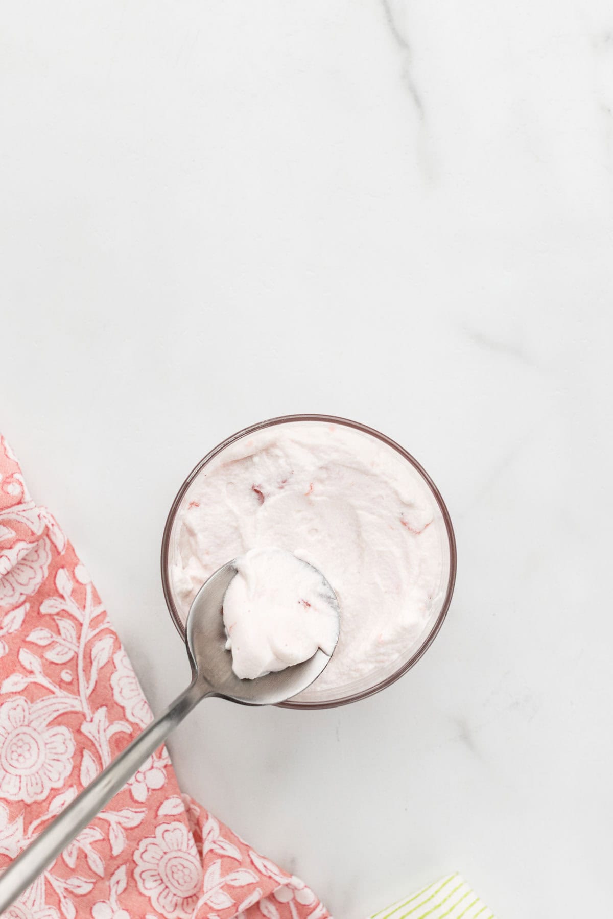 Creamy filling pressed into a cup with a spoon.