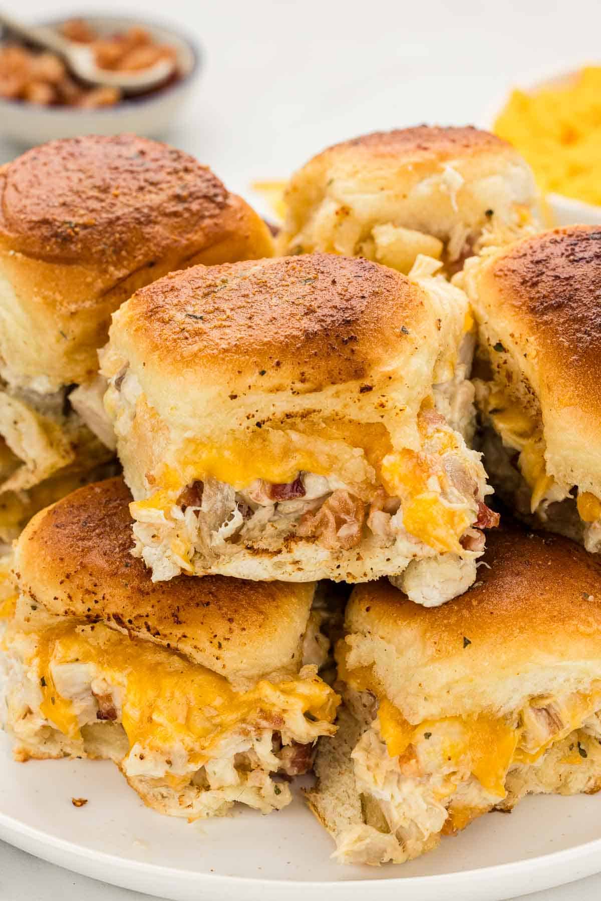 A stack of sliders on a serving plate.