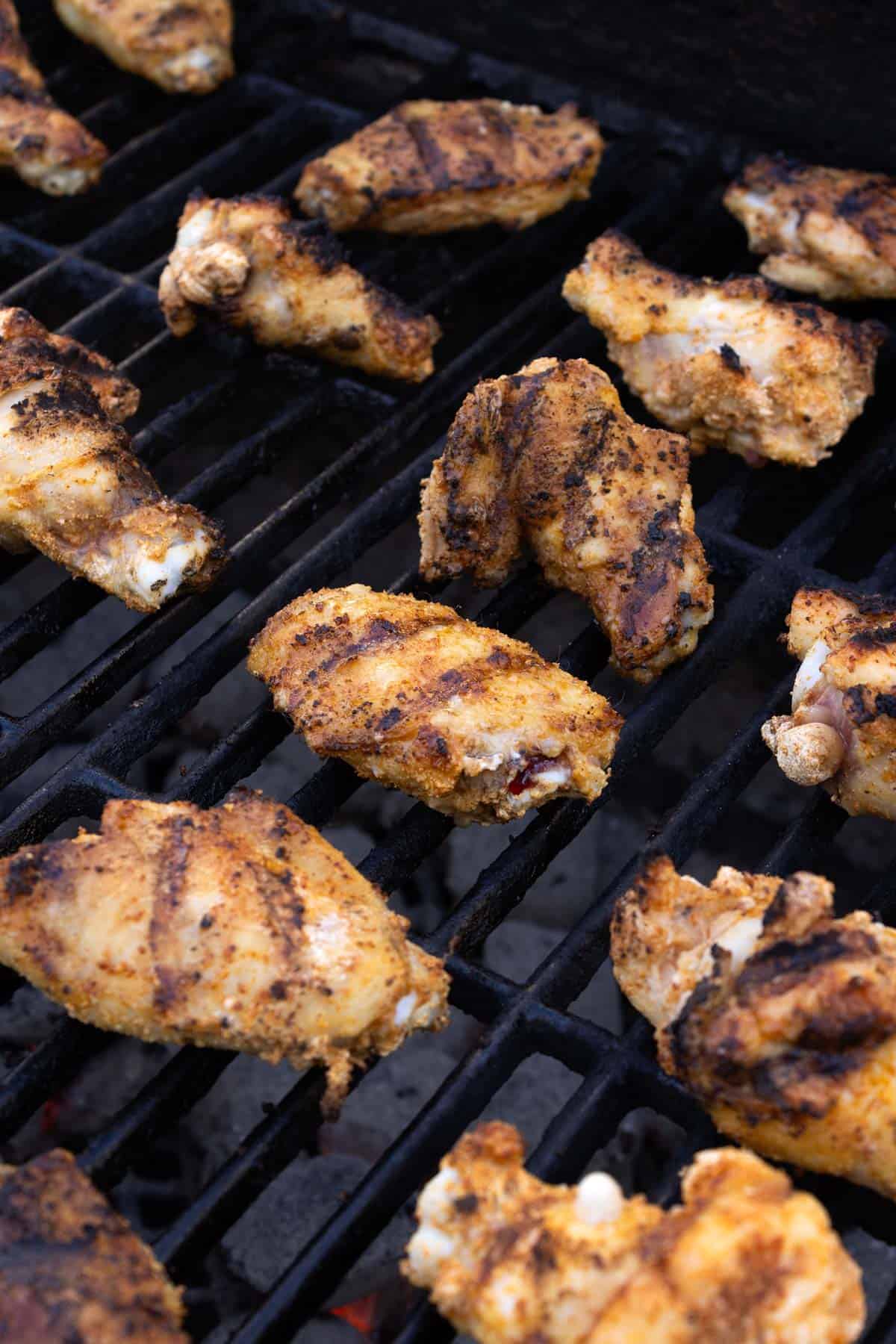Cooked wings on a grill.