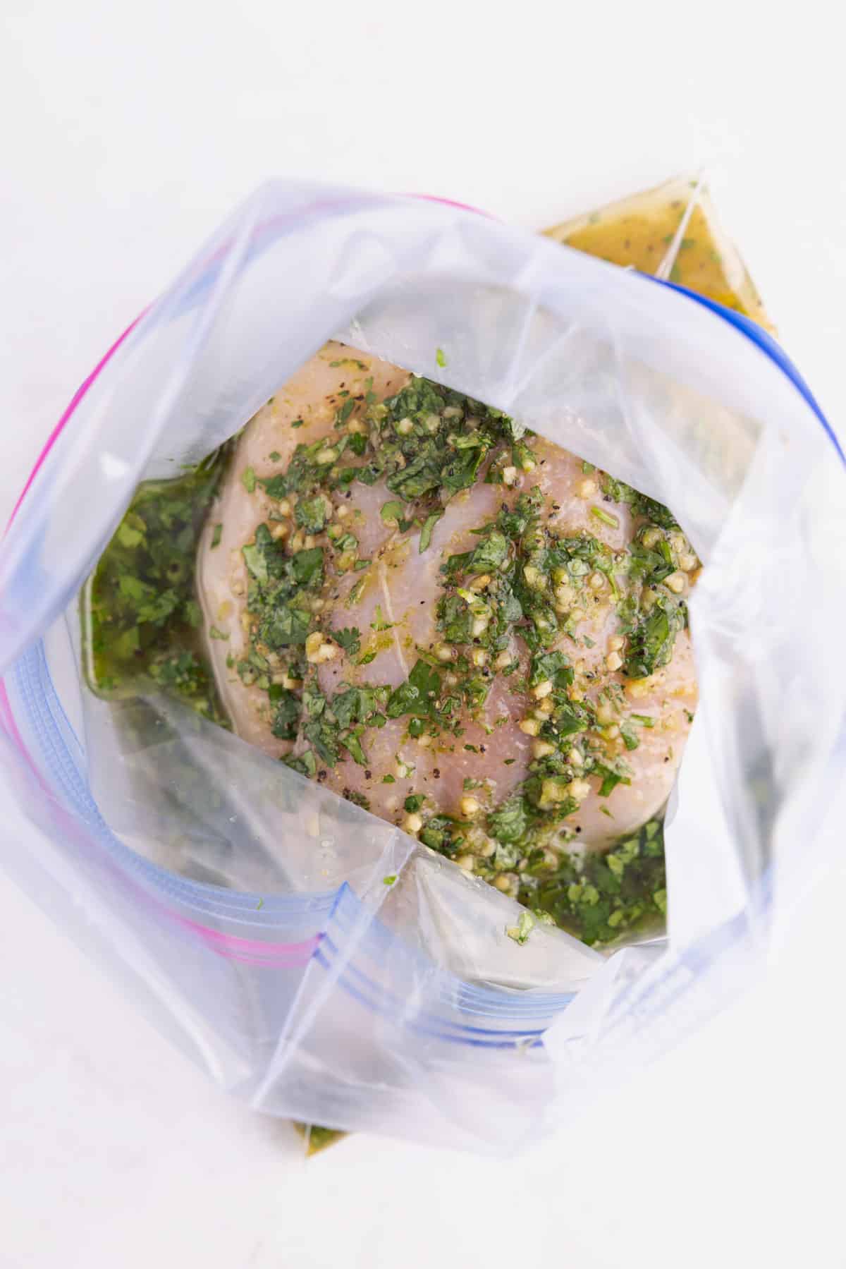 Raw chicken soaked in juices in a bag.