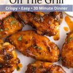 Closeup of chicken wings piled together with a graphic overlay.