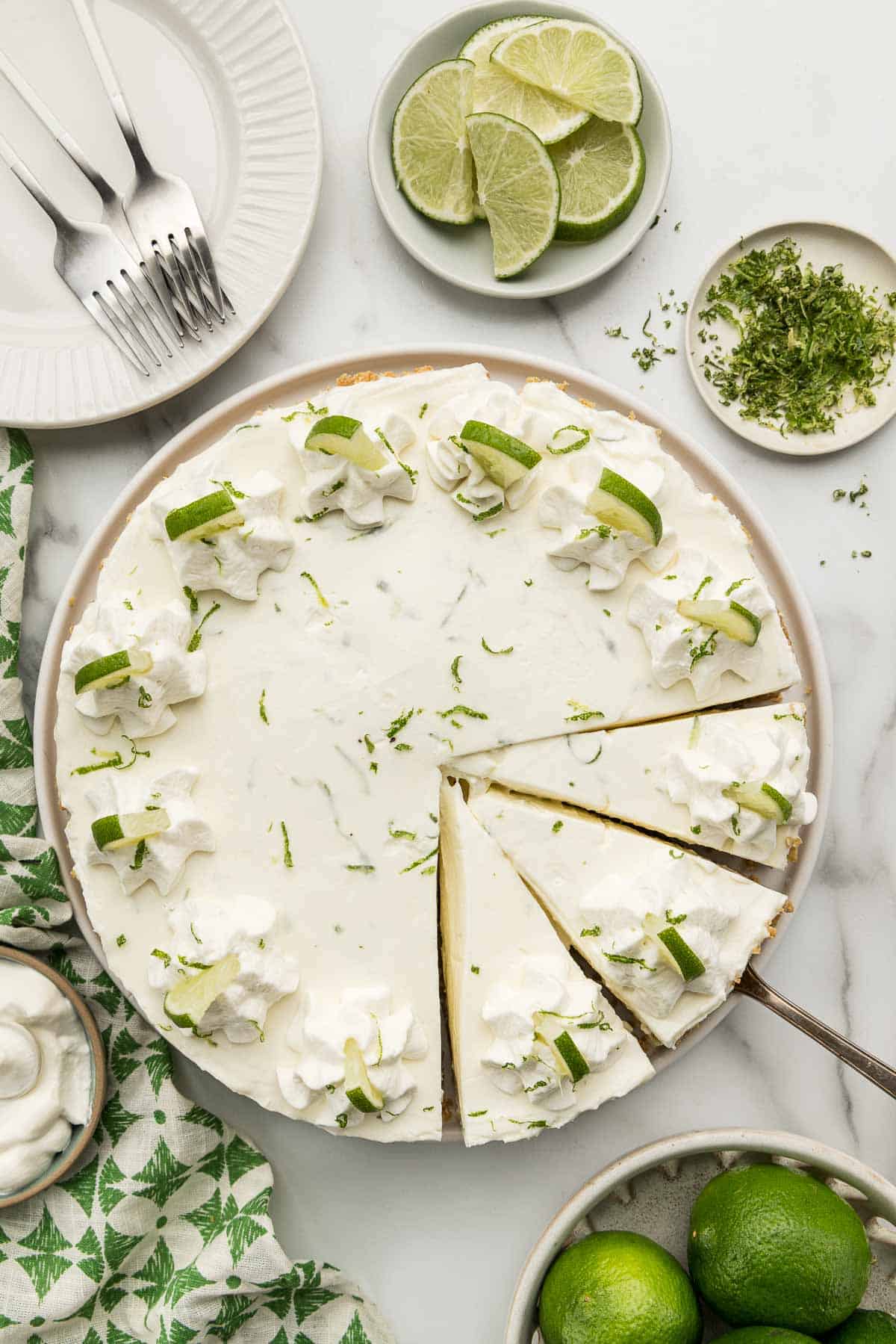 Overhead of a no bake key lime cheesecake with a couple slices in it.
