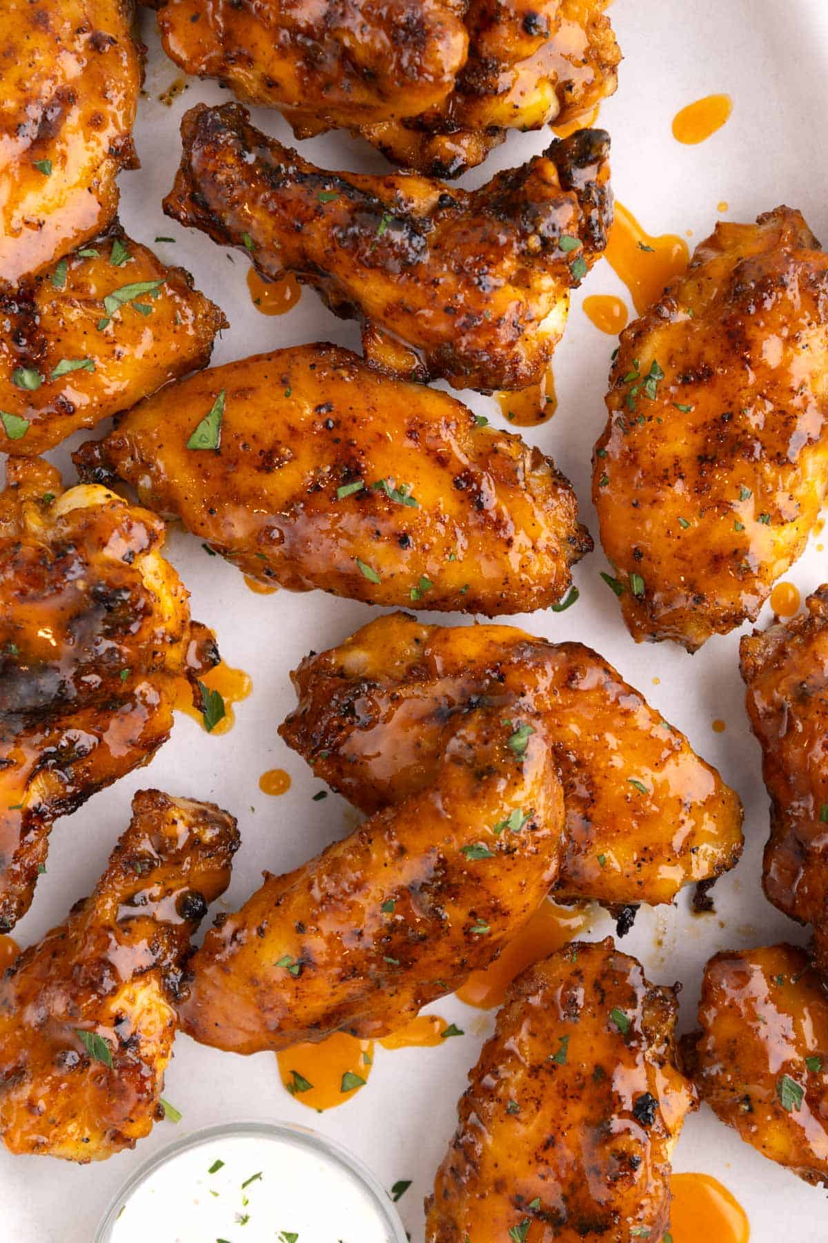 Grilled chicken wings clustered together drizzled in honey buffalo sauce.