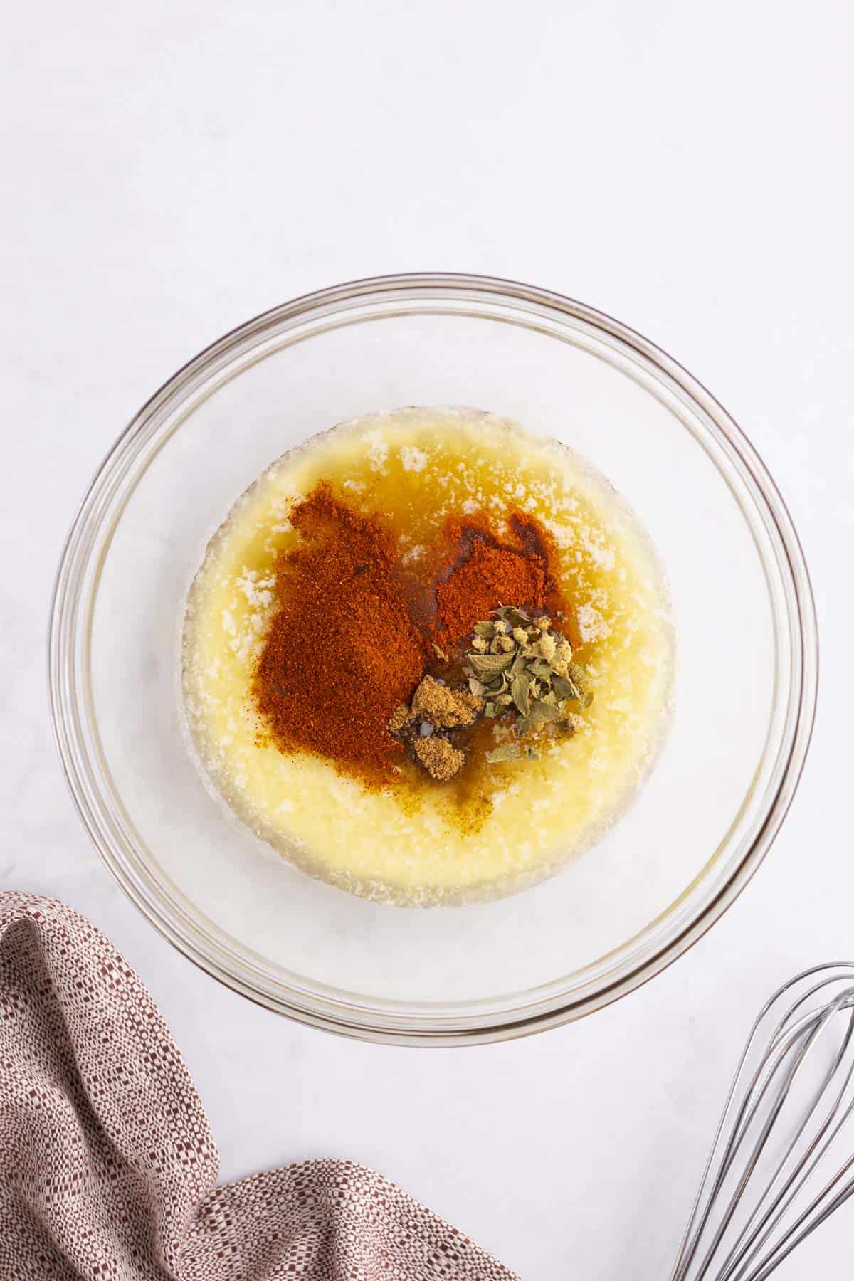 Honey chipotle sauce ingredients unmixed in a glass bowl.