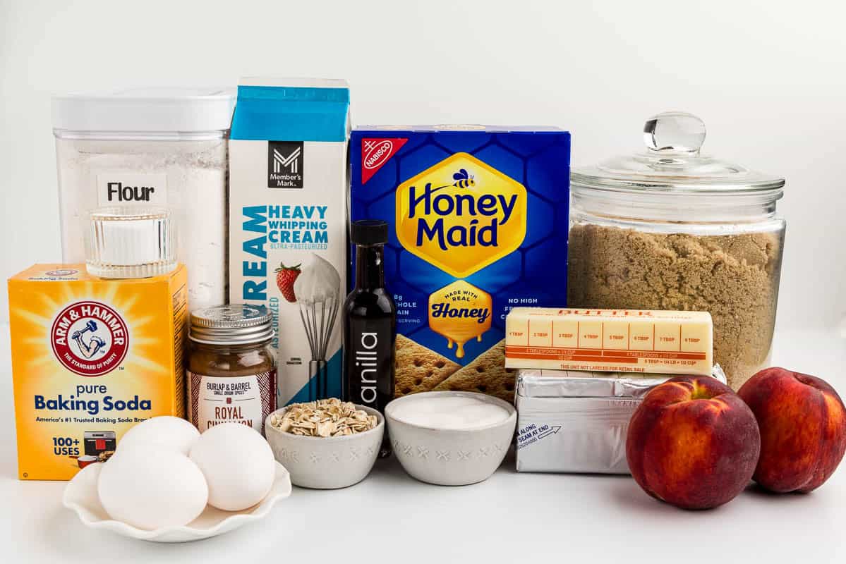 Peach cheesecake ingredients on a white countertop.