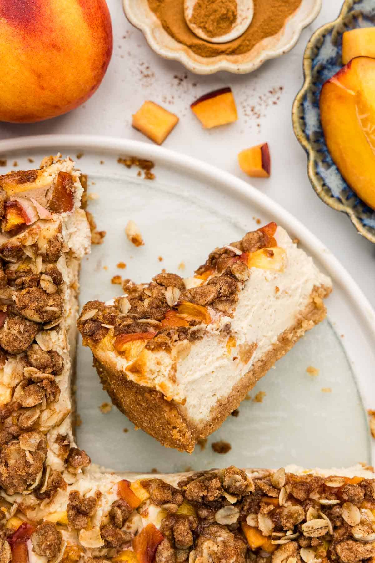 A slice of peach cheesecake tipped on its side.
