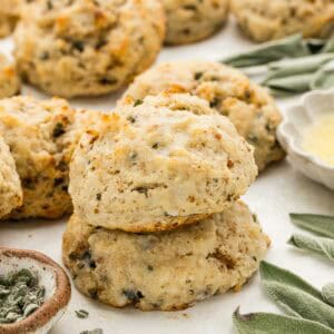 A stack of biscuits with an array of ingredients around them.