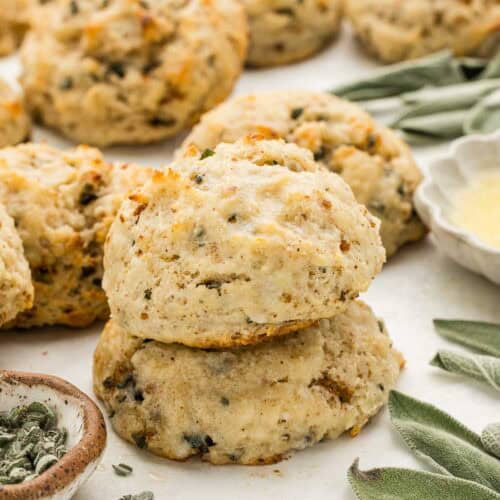 A stack of biscuits with an array of ingredients around them.