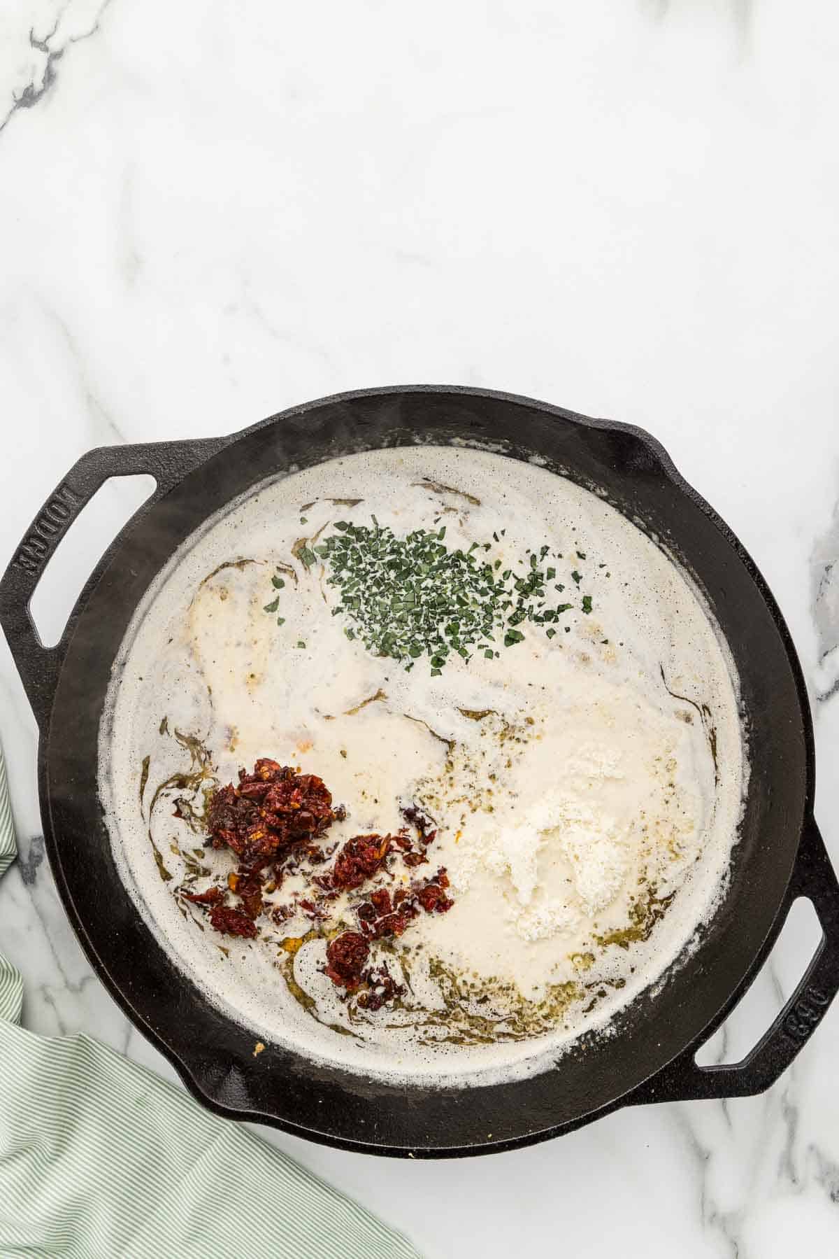 Marry me sauce ingredients in a large pan.
