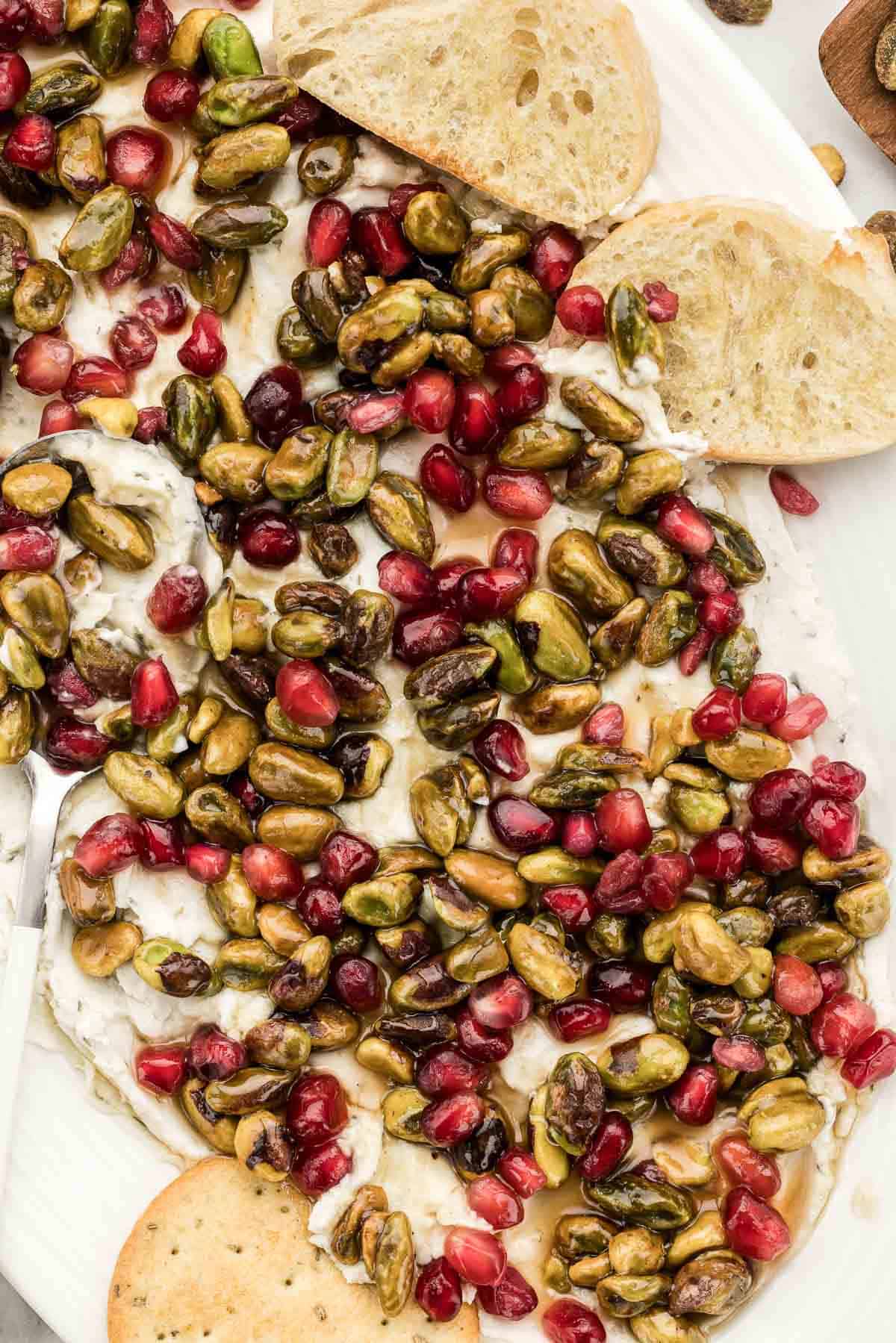 A white dish of boursin dip with crackers.